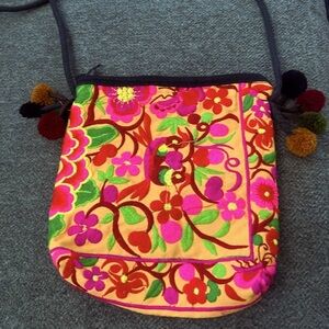 Embroidered floral crossbody bag with pompoms
